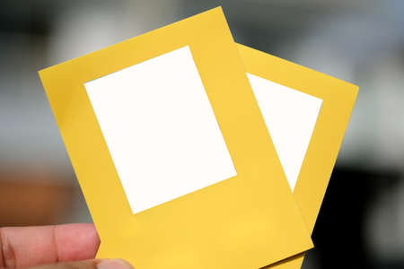 Man hand holding of yellow tag with empty blank spec for your textの写真素材