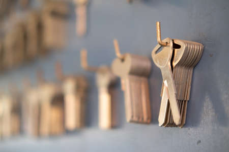 Close up of key hanging on wall in key maker shop. Locksmith Key shop