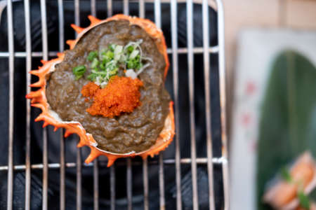 Japanese Kani Miso crab meat with soybean paste grilled in crab shell at traditional Japanese restaurant. Selective focus. Charcoal grill.の写真素材