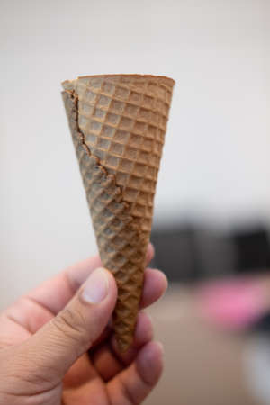 Empty ice cream waffle cones without ice cream in hand