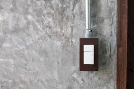 White light switch on grey concrete wall loft style