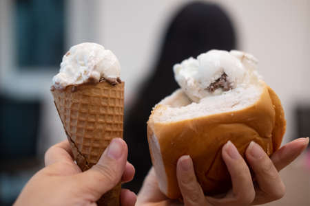 Ice cream on cone and ice cream in bread the fresh coconut milk in hand. Two hand