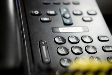 Close up of black office phone. Close up number