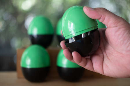 Hand open randomly plastic egg or egg surprise toys. Concept of egg surpriseの写真素材