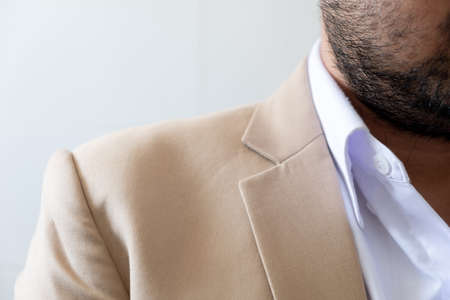 Close up portrait of businessman with beard and mustache wearing cream suitの写真素材