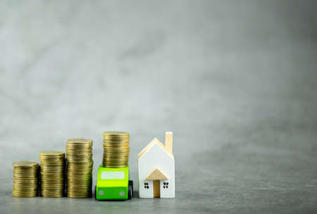 Pile of gold coins, car and house for savings buy a home or car. Divide the investment for...