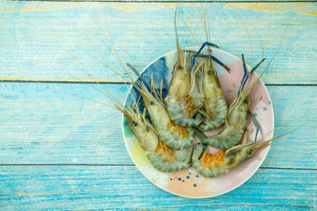 Whole fresh raw shrimps seafood in plate ready to cookの写真素材