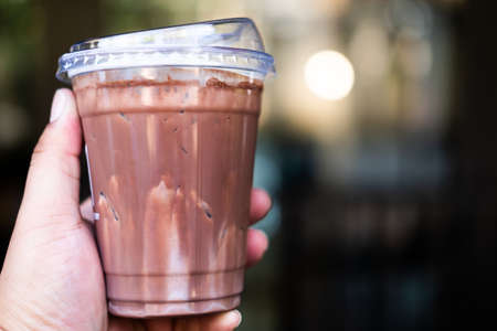 Iced cocoa in plastic cup with lid. Lid design for drink for reduce use of straw, you can drink coffee pass lidの写真素材