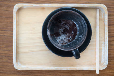 Empty hot chocolate cup after drink on wood trayの写真素材