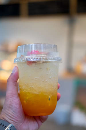 Close up a glass of fresh passion fruit juice mix with soda. Refreshing drink
