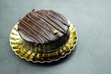 Mini mousse cake with chocolate on black background