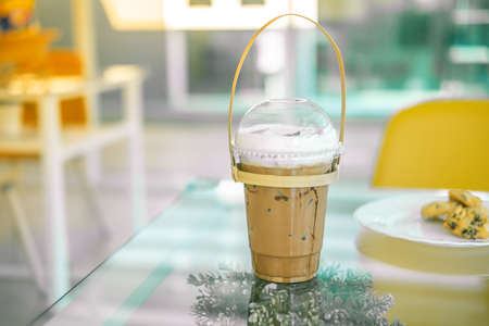 Iced coffee mocha in a plastic cup with handle make from bamboo carry at coffee shop. Concept of reduce plasticの写真素材