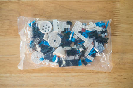 Plastic mini blocks in transparent bag for creative building up to imagination on wood table