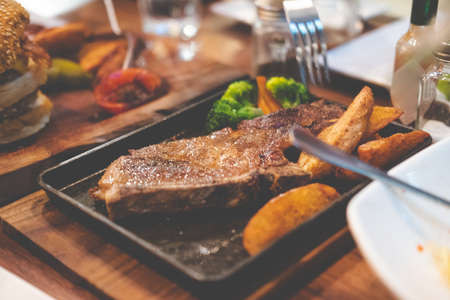 Pork chop or grilled pork served with french fries on table dinnerの写真素材