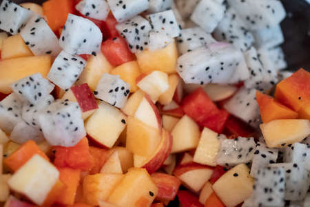 A close up image of fruit salad : Dragon fruit, apple, cantaloupe,watermelon