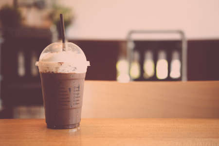 Iced coffee mocha coffee with foam milk in plastic glassの写真素材