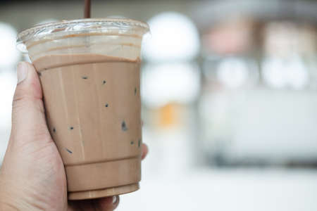Close up of iced mocha coffee in man handの写真素材