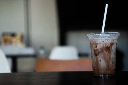Delicious iced mocha in clear plastic glass, showing the texture of chocolate sauce in glassの写真素材