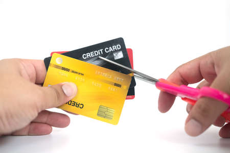 Cutting up a credit card with scissors isolated on a white background