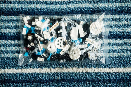 Multicolored plastic building blocks of the designer in bag. Background of plastic colored details building blocksの写真素材