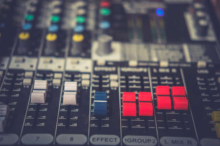 Detail with adjusting knobs on a professional audio mixer and music equipment for sound mixer...