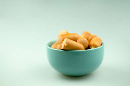Hot dog sausages on blue bowl. Concept of appetizerの写真素材