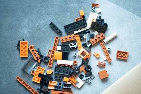 Toy colored plastic block of various sizes on stone background
