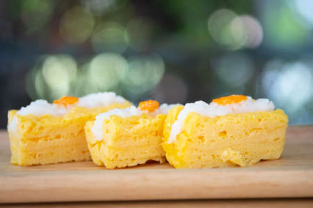 Close up of grilled tamago sushi with rice and ebiko