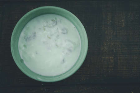 Bowl of white yogurt  on wood table