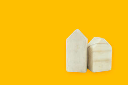 Wooden toy home on yellow background. Clipping pathの写真素材