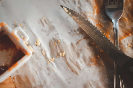Leftover food with a knife and fork. Close upの写真素材
