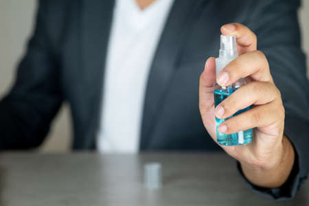 Businessman hands using alcohol sanitizer. Promoting people use face mask to protect themselves from virus infection in Corona virus crisis 2020の写真素材