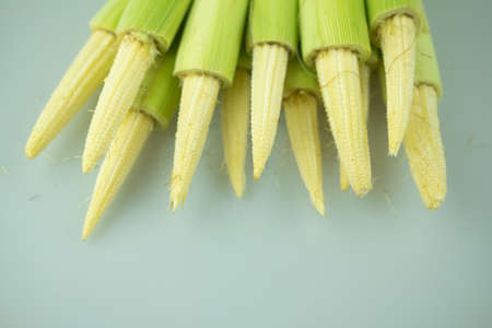 Close up of a pile of baby corn ready to be cookedの写真素材