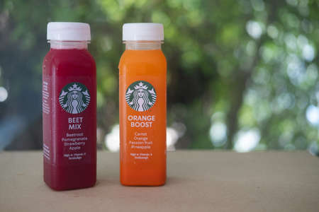 Samut Prakan, Thailand - April 26 2020 : Special health drink from Starbucks Thailand : Orange boost  High Vitamin A (carrot,orange,passion fruit,pineapple,) and Beet mix High Vitamin C (beetroot,pomegranate,strawberry,apple)のeditorial素材