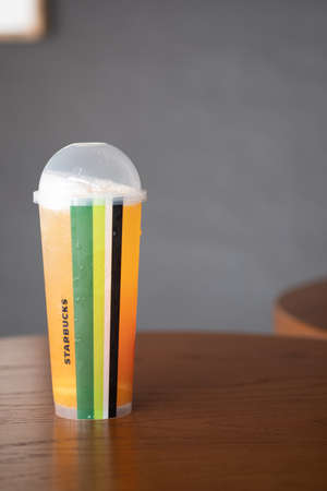 Samut Prakan, Thailand - April 26 2020 : New beverages remixed and all so fruity, flavorful and refreshing. Tropical triple citrus green tea mixed with of three orange juices topped with grapefruit, lemon and oranges slices.のeditorial素材