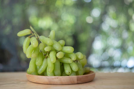 Fresh fruit brunch green grapes on wooden dishの写真素材