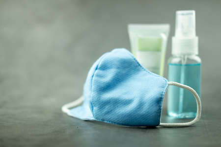 Blue protective mask on black background. Anti-virus masks made of cottonの写真素材