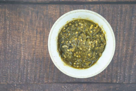 Nam Prik Num (Northern Thai Green Chilli Dip) on wood table. Thai Lanna foodの写真素材