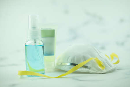 Mask n95 and a spray of alcohol for hand hygiene. Protect people from coronavirus disease covid-19の写真素材