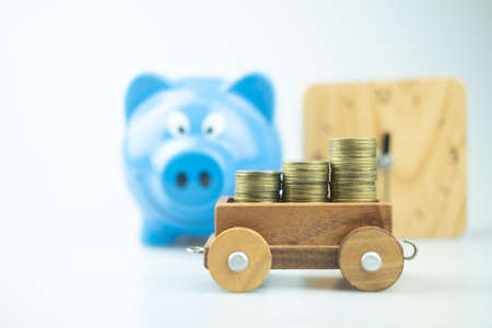 Blue piggy bank and stock of gold coins. Money concept.の写真素材