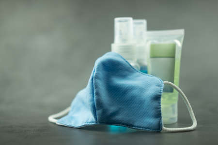 Face mask, alcohol spray and sanitizer hand gel. People using to protect and wash hands to prevent COVID-19 virusの写真素材