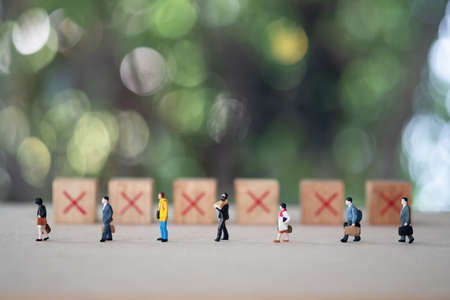 Miniature people keeping distance for infection risk and disease for prevent virus Covid-19. Social Distancing concept. Health care concept.の写真素材