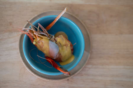 Homemade of big shrimp break with cheese in blue bowl. Top view
