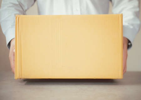 Delivery man holding cardboard box. Fast and free Delivery transport. Online shopping and Express...