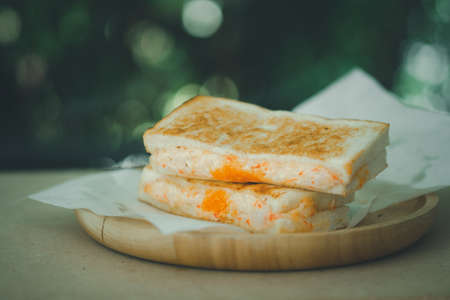 Sandwich stuffed with mayonnaise mix with shrimp egg on wooden dishの写真素材