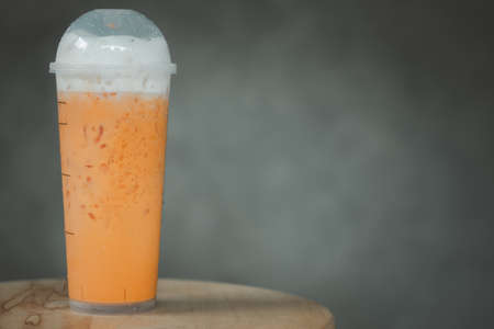Ice Thai milk tea with milk in transparent plasticの写真素材
