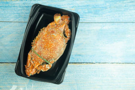 Fresh crab cooked pack in plastic box for delivery. Thai style seafood.の写真素材
