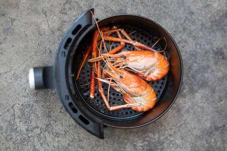 River shrimp cooked in black air fryer. Easy cooking in house conceptの写真素材