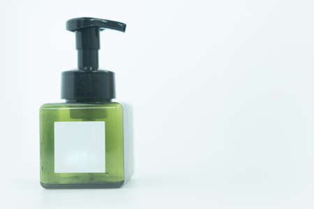 Green plastic bottle with black pump for liquid soap or body cream care. Healthcare and business concept.の写真素材