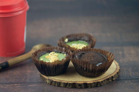 Chocolate brownie tart with various of topping on wood table
